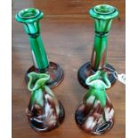 A pair of glazed pottery candlesticks 18cms high a