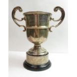 A silver two handled trophy cup, inscribed, with a