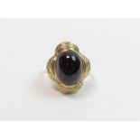 A cabochon garnet ring, with glazed locket back an