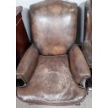 A Victorian style leather upholstered armchair wit