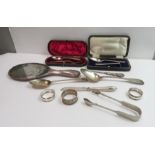 A cased silver spoon and pusher set; a cased spoon