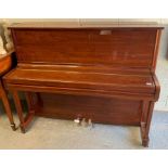 A Samick upright piano in bright mahogany case,