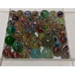 A collection of glass marbles the majority with