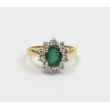 An emerald and diamond 18 carat gold cluster ring,