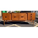 A mid-20th century teak sideboard fitted with pair of