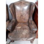 A Victorian style leather upholstered wing back ar