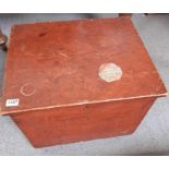 A stained wooden box on casters containing a large