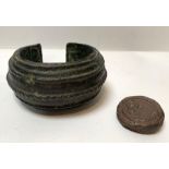 An antique heavy bronze amulet and a metal seal (2
