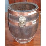 A small coopered oak barrel with copper bands and