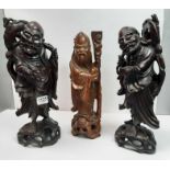 A pair of Oriental carved hardwood figures of Shou