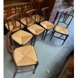 Set of 8 stained oak dining chairs with rush seats