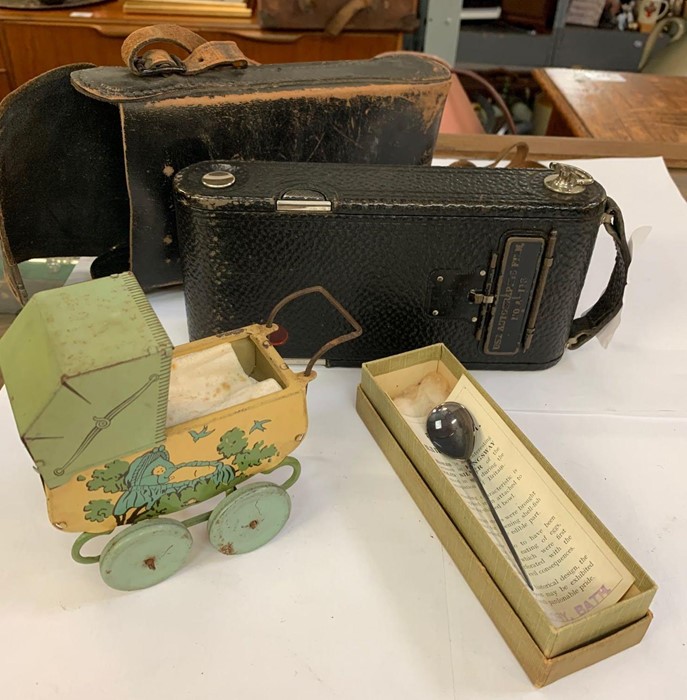 Old taste camera, child's tin plate pram & a boxed