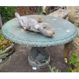 Circular stone garden table with fish as centrepie