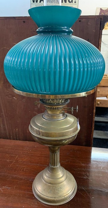 Brass oil lamp with ribbed green shade