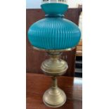 Brass oil lamp with ribbed green shade