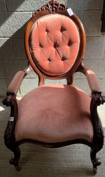 A 20th century mahogany button back open armchair