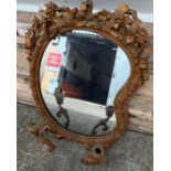 An unusual Victorian kidney shaped wall mirror, wi