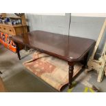 A 20th century mahogany extending dining table wit