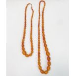 A row of graduated amber beads; and another simila
