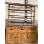 A 20th century pine dresser, the top of open shelf