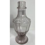 An 18th century facetted glass bottle, of baluster