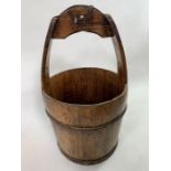 A 19th/20th century oak bucket, with shaped fixed