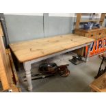 A modern pine kitchen table, with scrubbed top and
