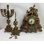 A gilt mantel clock with a male figure riding a ho