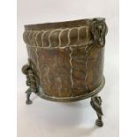 A brass jardiniere with embossed and engraved deco