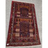 A Middle Eastern wool rug having central panels wi