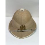 A 19th/20th century military pith hat, retailed by Griffiths Mcallister