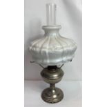 A 20th century lamp with a chrome base and milk gl