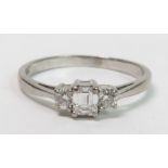 An 18 carat white gold three stone diamond ring, t