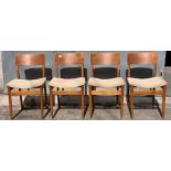 A set of four mid century dining chairs, each in el