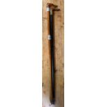 A Victorian beech walking cane, the handle modelle