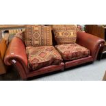 A 20th century two seat sofa, with red leather cov