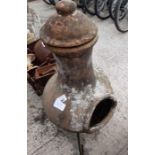 Terracotta chiminea on metal stand