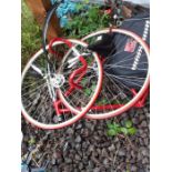 Red men's road bicycle with panniers