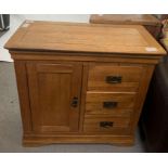 Modern light oak cupboard with single drawer openi