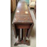 20th Century stained oak carved drop leaf table