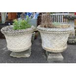 Pair of stone planters with basket weave & flower