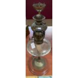 A Victorian faceted glass oil lamp supported on br
