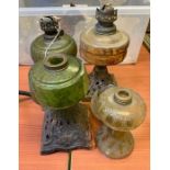 Three Victorian oil lamps with coloured glass rese