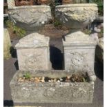 Pair of reconstituted stone urn planters on plinth