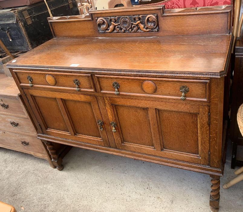 Oak sideboard with barley twist legs and decorativ