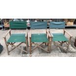 Three green canvas and wood directors chairs