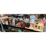 Shelf of items to include metronome, dolls house,