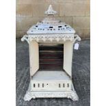 An early 20th century white painted metal heater,