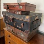 A vintage black travelling trunk with brown leathe