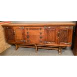 A 20th century carved oak sideboard, the centre wi